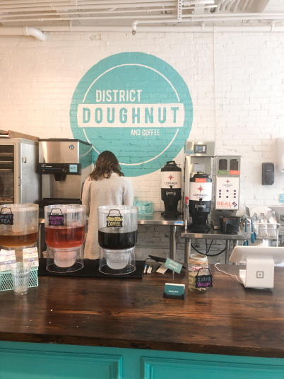 An employee making coffee at District Doughnut, a shop in Washington, D.C.
