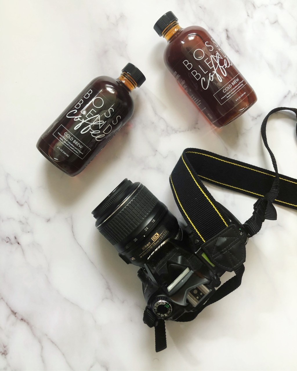 A camera with Boss Blend Coffee bottles