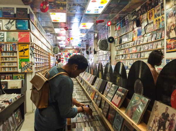 A woman looking at records in a record store in San Diego, CA