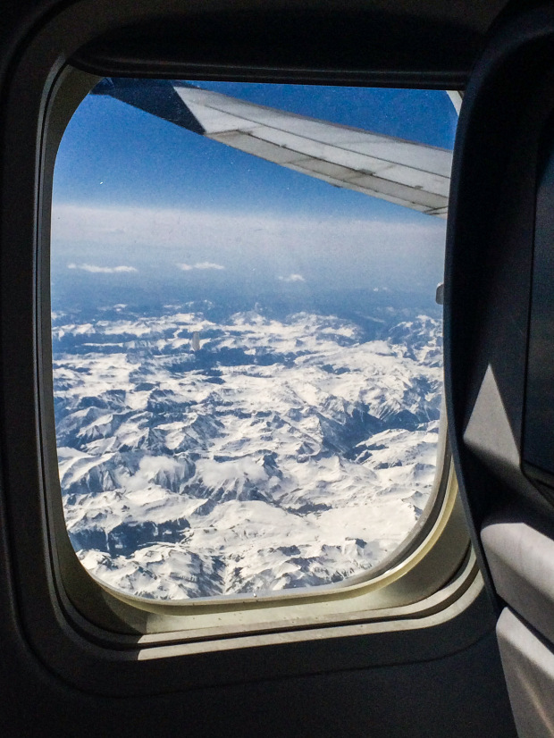 Snowcaps of mountains in Colorado outside of a plane window