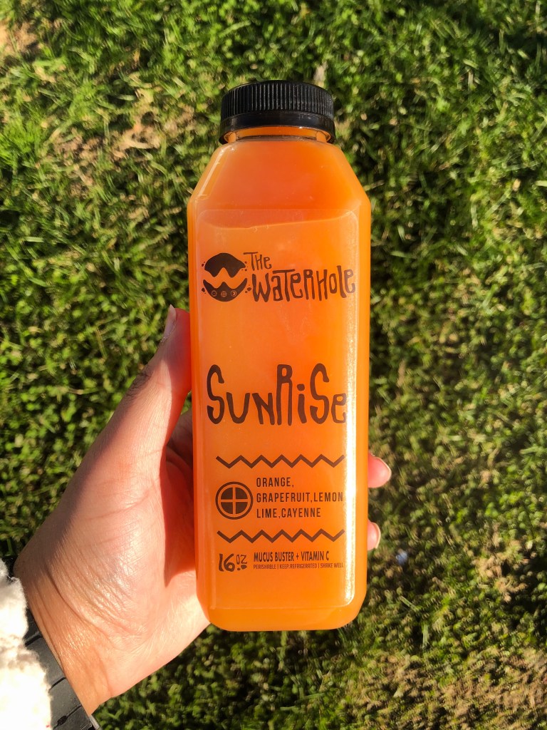 The Waterhole's Sunrise juice made with orange, grapefruit, lemon, lime, and cayenne. The Waterhole is a Black-owned juice shop in Maryland.