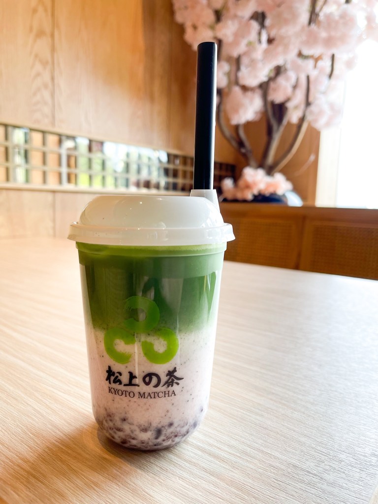 A matcha latte with red bean on a table inside of Kyoto Matcha, a dessert shop in Ellicott City.