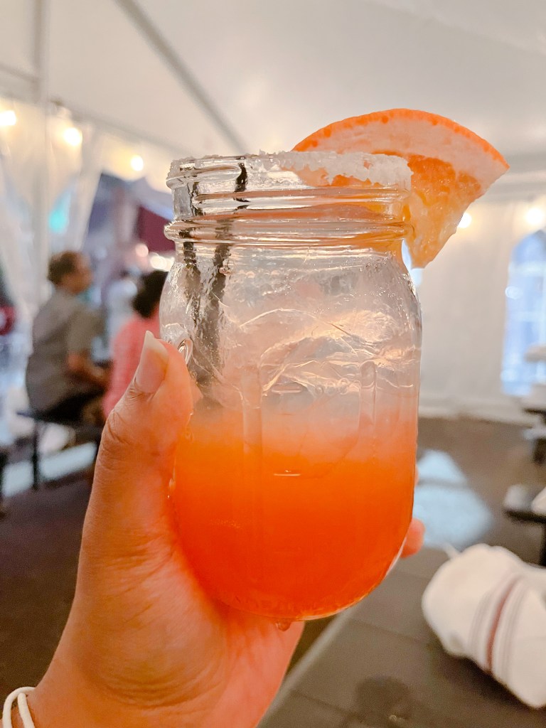 A hand holding a Paloma from Iron Rooster, a restaurant located in Annapolis, Maryland.