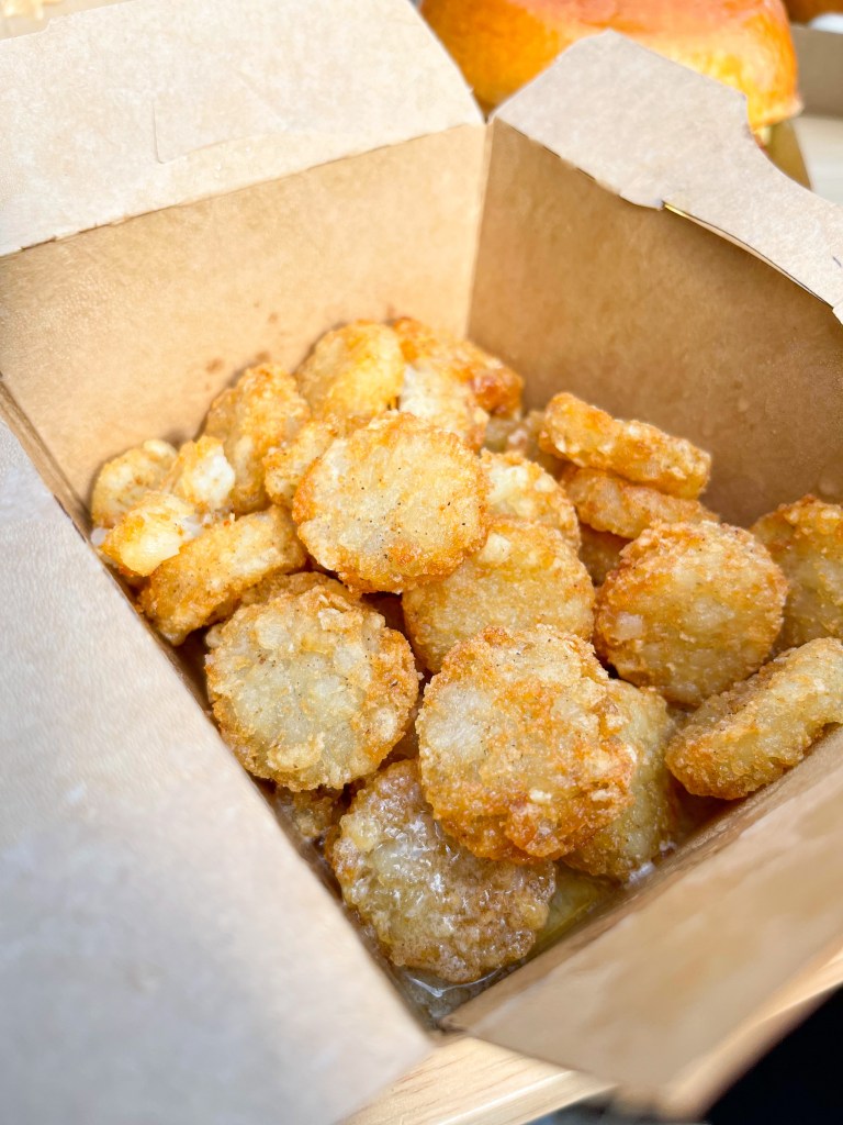 A box of tater tots from Cracked Eggery, which is a restaurant in Washington, D.C. The flavor is Honey Butter.