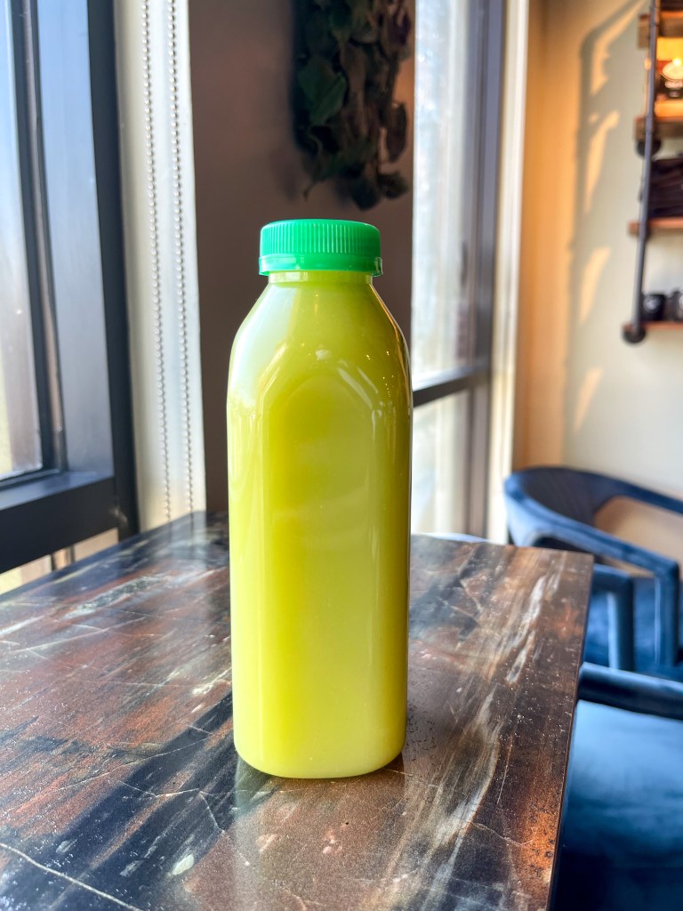 A bottle of fruit juice sitting on a countertop. The juice is from Love Life Cafe, which is a Black-owned cafe in Laurel, Maryland.