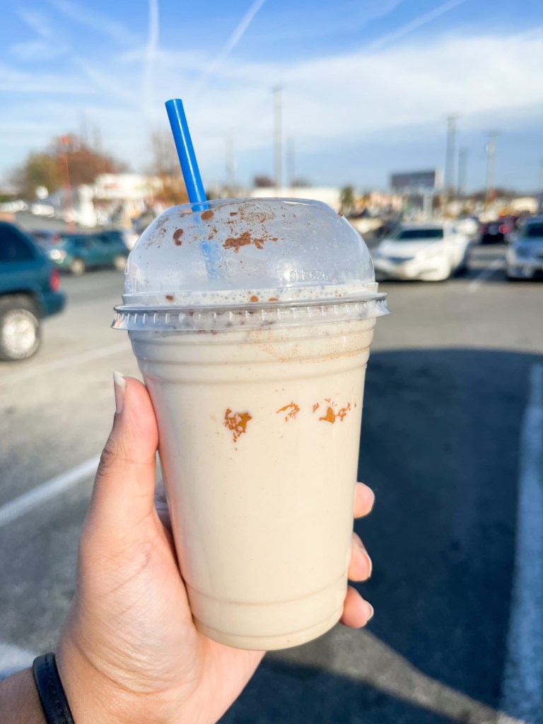 A hand holding a drink