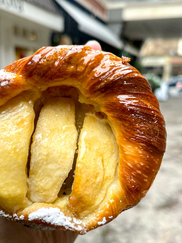 A hand holding an apple tart from maman, a cafe in Bethesda, Maryland