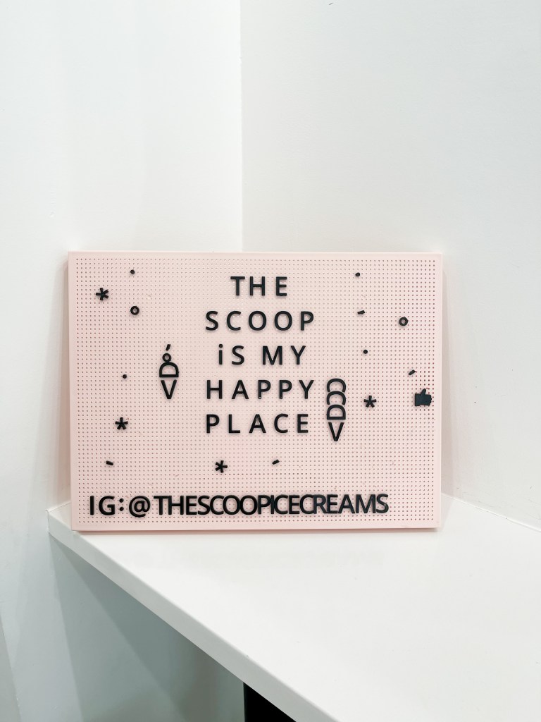 A sign that says, "The Scoop is my happy place"