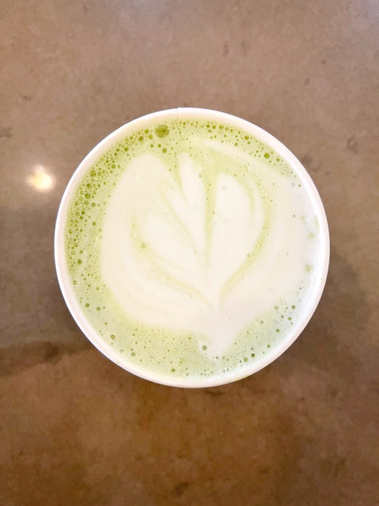 A matcha latte sitting on a countertop